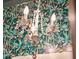 White chandelier in a small bathroom with tropical wallpaper at 12 Bee Street St # A, Charleston, SC 29403