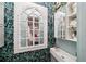 Small bathroom with a sink, tropical wallpaper, and built-in shelving at 12 Bee Street St # A, Charleston, SC 29403