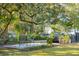 Peaceful garden with seating area and mature trees at 12 Bee Street St # A, Charleston, SC 29403