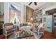 Charming living room with exposed brick, hardwood floors, and comfy seating at 12 Bee Street St # A, Charleston, SC 29403