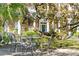Small patio with metal table and chairs, nestled under a large tree at 12 Bee Street St # A, Charleston, SC 29403