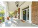 Spacious front porch with seating and classic columns at 12 Bee Street St # A, Charleston, SC 29403