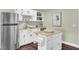 White cabinets and butcher block island highlight this basement kitchen at 1201 Roma Rd, Hanahan, SC 29410