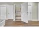 Open door revealing a wooden staircase leading upstairs at 1201 Roma Rd, Hanahan, SC 29410
