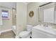Updated bathroom features a white vanity, toilet, and shower with tile surround at 1201 Roma Rd, Hanahan, SC 29410