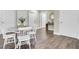 Bright dining area with wood table and white chairs, hardwood floors at 1201 Roma Rd, Hanahan, SC 29410