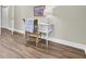 Home office with white desk and rattan chair, hardwood floors at 1201 Roma Rd, Hanahan, SC 29410