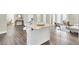 Open concept kitchen features island, hardwood floors, and access to living area at 1201 Roma Rd, Hanahan, SC 29410