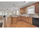Spacious kitchen with an island, granite countertops, and wooden cabinets at 1201 Roma Rd, Hanahan, SC 29410