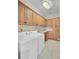 Laundry room with white appliances and ample wooden cabinetry at 1201 Roma Rd, Hanahan, SC 29410