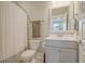 Clean bathroom with gray vanity, white toilet, and shower at 128 Sandy Bend Ln, Summerville, SC 29486