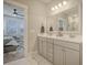 Double vanity bathroom with marble tile and a large mirror at 128 Sandy Bend Ln, Summerville, SC 29486