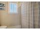 Simple bathroom with shower, gray striped curtain, and a window at 128 Sandy Bend Ln, Summerville, SC 29486