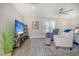 Relaxing bedroom with seating area, large TV, and ceiling fan at 128 Sandy Bend Ln, Summerville, SC 29486