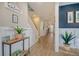Spacious entryway with wood-look floors, an elegant staircase, and charming decor at 128 Sandy Bend Ln, Summerville, SC 29486