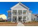 Two-story home with a large front porch and rocking chairs at 128 Sandy Bend Ln, Summerville, SC 29486