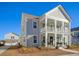 Charming two-story home with a front porch and landscaped yard at 128 Sandy Bend Ln, Summerville, SC 29486