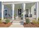 Inviting front porch with a porch swing and rocking chairs at 128 Sandy Bend Ln, Summerville, SC 29486