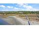 Aerial view of waterfront property with a long boardwalk and boat dock at 153 Dewees Inlet Dr, Dewees Island, SC 29451