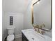 Powder room with gold fixtures and marble vanity at 153 Dewees Inlet Dr, Dewees Island, SC 29451