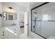 Modern bathroom with white vanity, marble countertop, and frameless glass shower at 153 Dewees Inlet Dr, Dewees Island, SC 29451