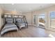 Bedroom with twin beds, bunk bed, hardwood floors, and water views at 153 Dewees Inlet Dr, Dewees Island, SC 29451