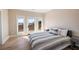 Bedroom with striped bedding and access to a deck at 153 Dewees Inlet Dr, Dewees Island, SC 29451