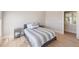Bright bedroom with gray bedding and hardwood floors at 153 Dewees Inlet Dr, Dewees Island, SC 29451