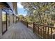 Long wooden deck overlooks a wooded area with stairs leading down at 153 Dewees Inlet Dr, Dewees Island, SC 29451