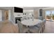 Bright dining area with white table and views of the water at 153 Dewees Inlet Dr, Dewees Island, SC 29451