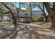 Elevated home with a large deck and stairs nestled amongst trees at 153 Dewees Inlet Dr, Dewees Island, SC 29451