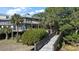 Elevated home with boardwalk access and lush landscaping at 153 Dewees Inlet Dr, Dewees Island, SC 29451