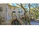 Elevated home with wooden deck and stairs leading down to the ground at 153 Dewees Inlet Dr, Dewees Island, SC 29451