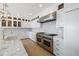 Modern kitchen features a professional range and marble countertops at 153 Dewees Inlet Dr, Dewees Island, SC 29451