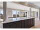 Large kitchen island with marble countertop and dark cabinetry at 153 Dewees Inlet Dr, Dewees Island, SC 29451