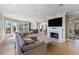 Bright living room features hardwood floors, fireplace, and water views at 153 Dewees Inlet Dr, Dewees Island, SC 29451