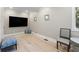 Media room with large TV and light hardwood floors at 153 Dewees Inlet Dr, Dewees Island, SC 29451