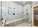 Large walk-in marble shower with dual shower heads and bench at 153 Dewees Inlet Dr, Dewees Island, SC 29451