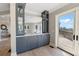Built-in wet bar with glass-front cabinets and marble top at 153 Dewees Inlet Dr, Dewees Island, SC 29451
