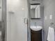 Small bathroom with white tile shower and dark vanity at 157 Line St, Charleston, SC 29403