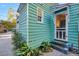 Side view of charming teal home with screen door and landscaping at 157 Line St, Charleston, SC 29403