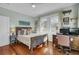 Bright bedroom with hardwood floors, built-in desk, and a comfortable bed at 186 Sans Souci St, Charleston, SC 29403