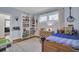 Playful bedroom with built-in shelving and hardwood floors at 186 Sans Souci St, Charleston, SC 29403