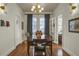 Charming dining room with hardwood floors, stylish light fixture, and window curtains at 186 Sans Souci St, Charleston, SC 29403