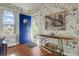 Bright entryway with floral wallpaper and blue door at 186 Sans Souci St, Charleston, SC 29403