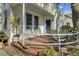 Inviting front porch with blue door and tiled floor at 186 Sans Souci St, Charleston, SC 29403