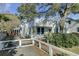 Charming home with a spacious front yard, large tree, and white fence at 186 Sans Souci St, Charleston, SC 29403