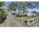 Charming home with a spacious front yard, large tree, and white fence at 186 Sans Souci St, Charleston, SC 29403