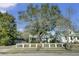 Charming home with a spacious front yard, large tree, and white fence at 186 Sans Souci St, Charleston, SC 29403