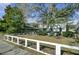 Charming home with a spacious front yard, large tree, and white fence at 186 Sans Souci St, Charleston, SC 29403